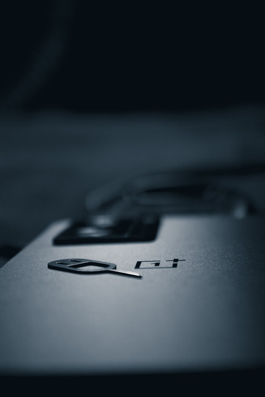 monochrome shot of a smart phone with a sim card key